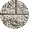 A round, textured stone divided into four segments by two intersecting straight grooves, one horizontal and one vertical, forming a cross shape. The surface appears rough and uneven.